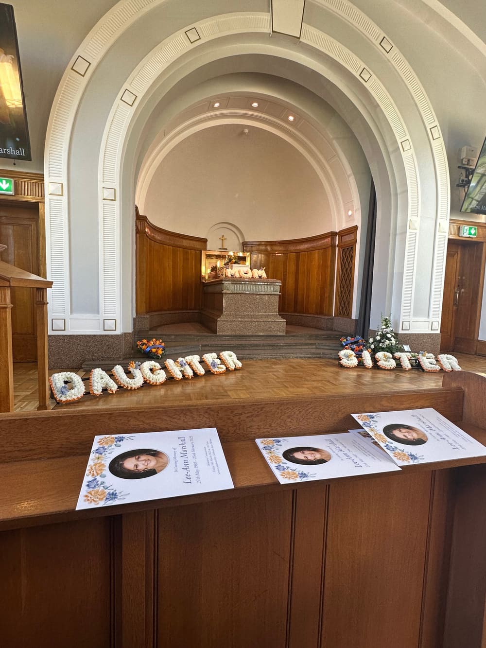 The chapel at Derek Elder's Mum's funeral, with flowers spelling Daughter and Sister in front of the altar